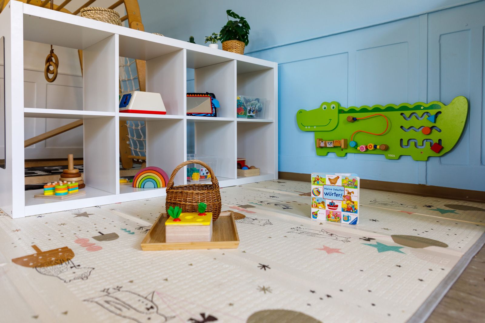 Spielregal mit Spielteppich und Krokodil-Wandspiel